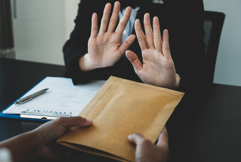 government officials raise the hand refusing money to take the b